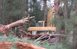 Greg Hutchens on the excavator clearing a fence line and barn site